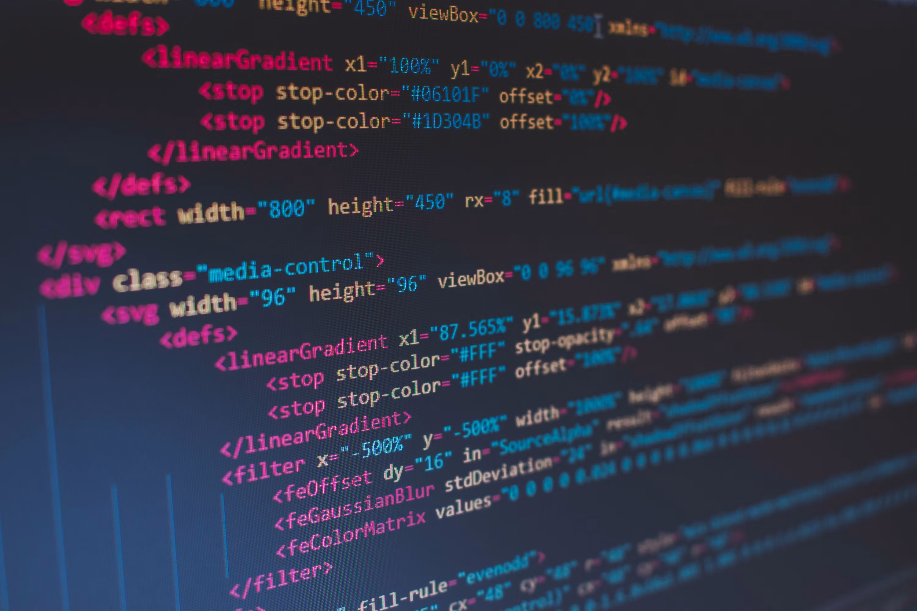 Website code displayed across computer screens